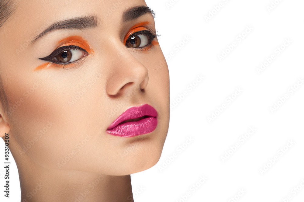 High fashion look, closeup beauty portrait of beautiful young woman model with bright makeup, perfect clean skin and colorful red pink lips and orange eyeshadow. High fashion look, closeup beauty portrait of beautiful young woman model with bright makeup, perfect clean skin and colorful red pink lips and orange eyeshadow.