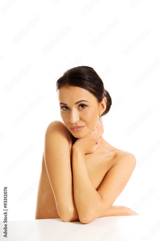 Topless woman sitting and looking at the camera Topless woman sitting and looking at the camera