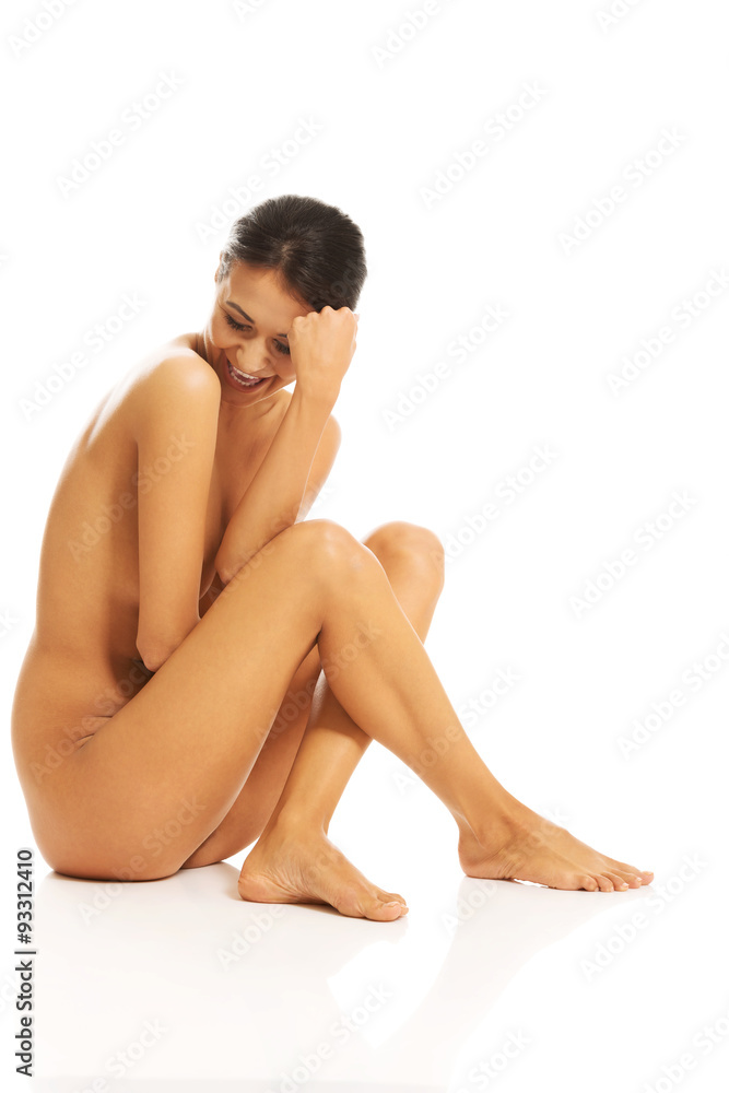 Side view of nude woman laughing and looking down