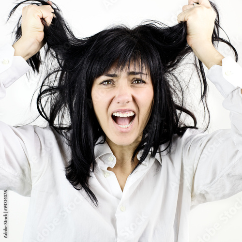 brunette woman screaming for her messy hair