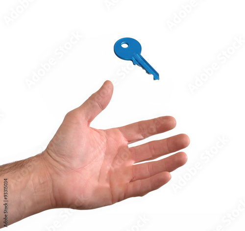 Mano recibiendo una llave.sujetando una llave azul.
