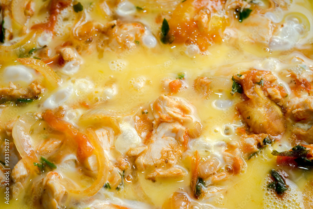 close up of cooking omelette with onion, tomatoes, chicken and parsley close up of cooking omelette with onion, tomatoes, chicken and parsley