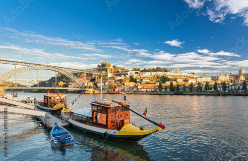 Porto city, Portugal October 17, 2013: Traditional boats in the Douro River near  bridge in sunny autumn day 