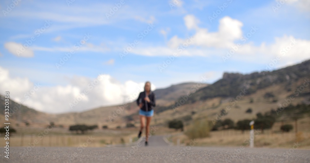 Fitress Girl Running on the Road in Mountains Fitress Girl Running on the Road in Mountains