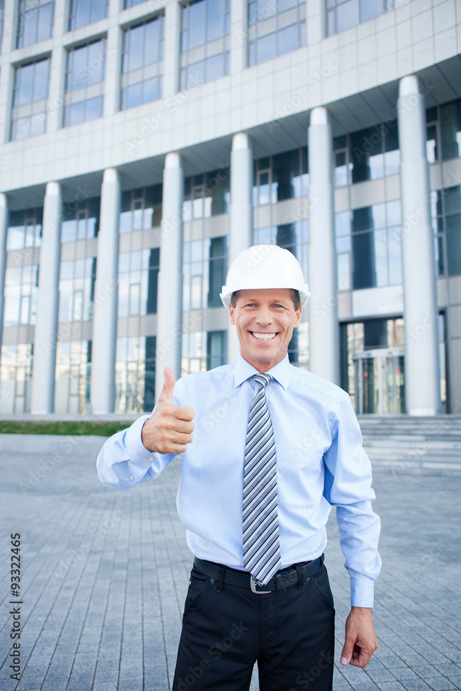 Cheerful senior engineer is gesturing with positive emotions Cheerful senior engineer is gesturing with positive emotions