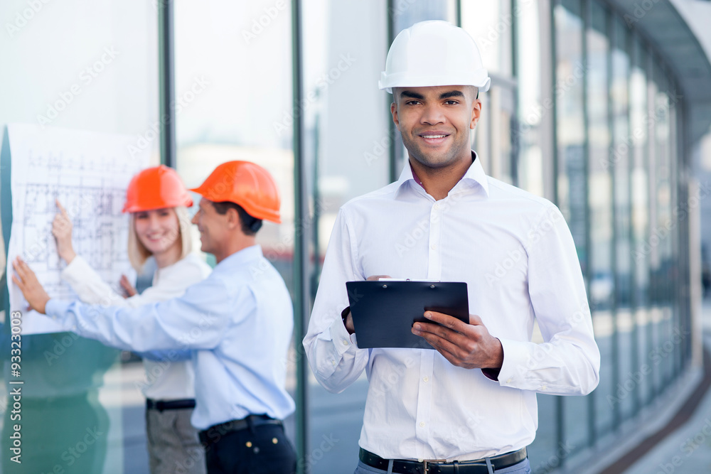 Skillful three builders are planning new project Skillful three builders are planning new project
