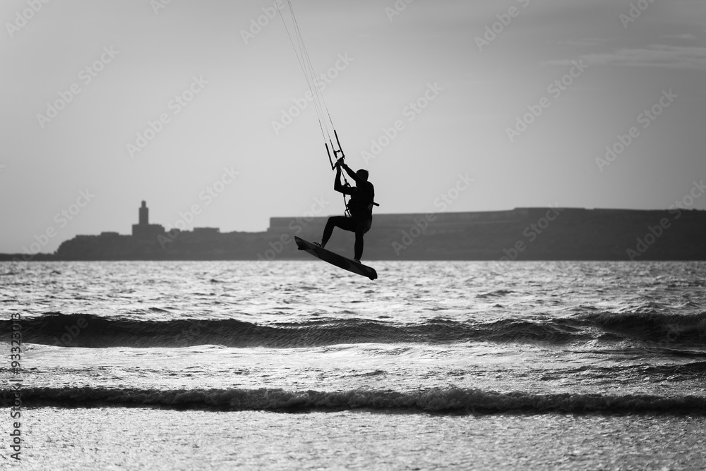 silhouette of a kite surfer at the beach