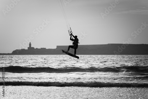 silhouette of a kite surfer at the beach