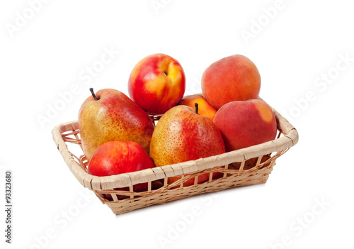 Fruits in a basket isolated on white background