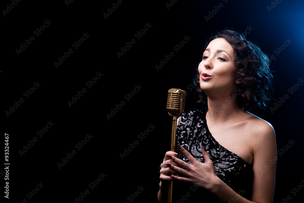 Beautiful girl singer singing emotional song with retro micropho
