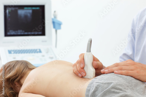 Child's lower back diagnosis carried out with the use of an ultrasound