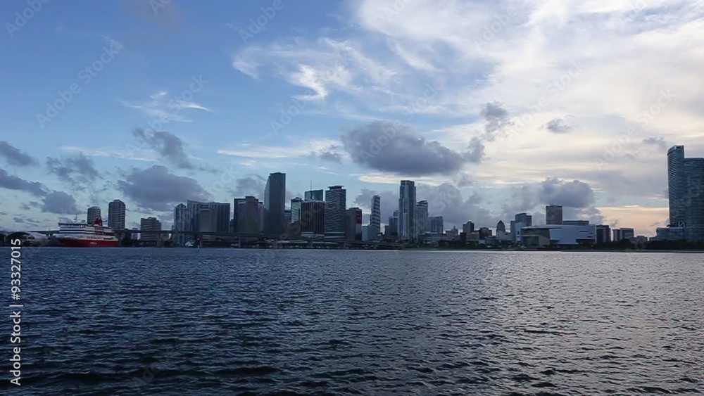 Miami city skyline panorama at dusk with urban skyscrapers over sea Miami city skyline panorama at dusk with urban skyscrapers over sea