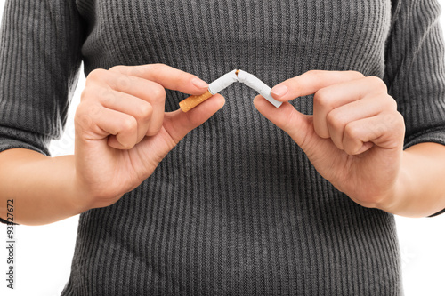 Female hands holding a broken cigarette