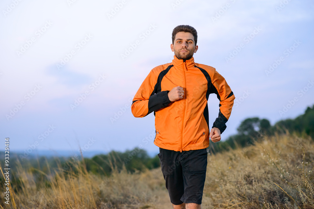 Young Man Running Outdoor on the Trail in the Park. Active Lifestyle