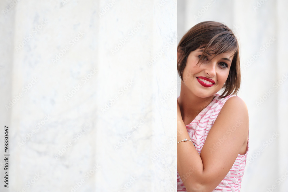 Fototapeta premium Portrait of smiling girl in urban background