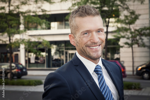 Mature Businessman Smiling At The Camera. He is outside of the office © annawin