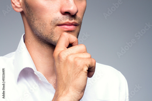 Close up portrait of thinking businessman on gray background