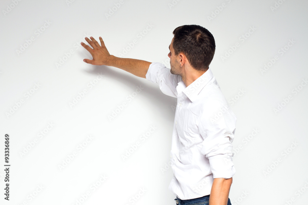 Business, education and office concept - businessman or teacher touching or moving on something from back on white background Business, education and office concept - businessman or teacher touching or moving on something from back on white background