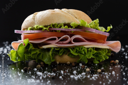 ham sandwich on black table