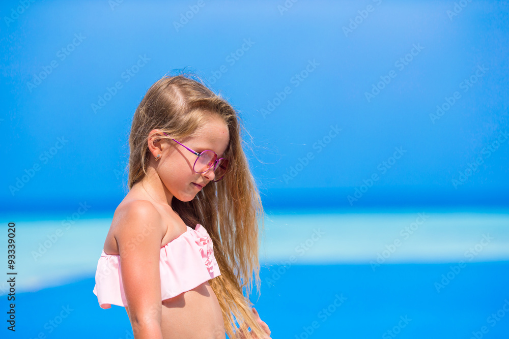 Portrait of beautiful little girl outdoor on beach vacation