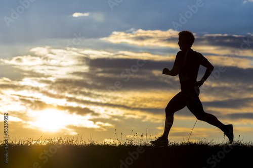 Fototapeta Naklejka Na Ścianę i Meble -  silhouette of a jogger in sunrise