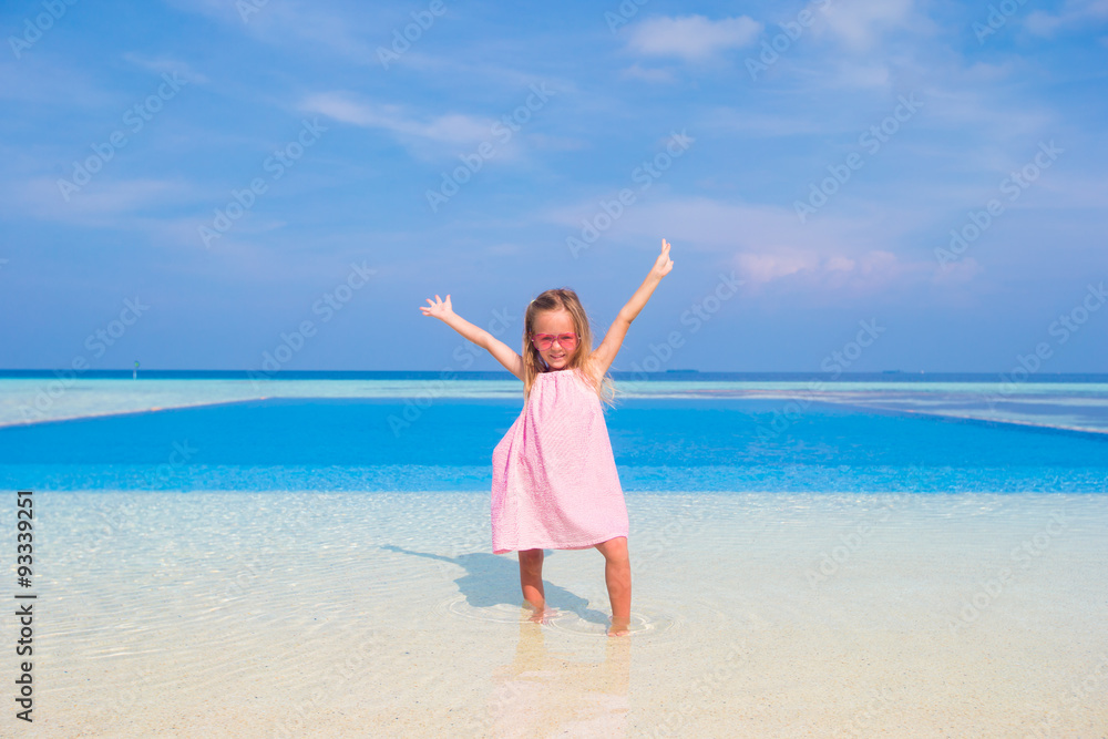 Adorable little girl at beach during summer vacation Adorable little girl at beach during summer vacation