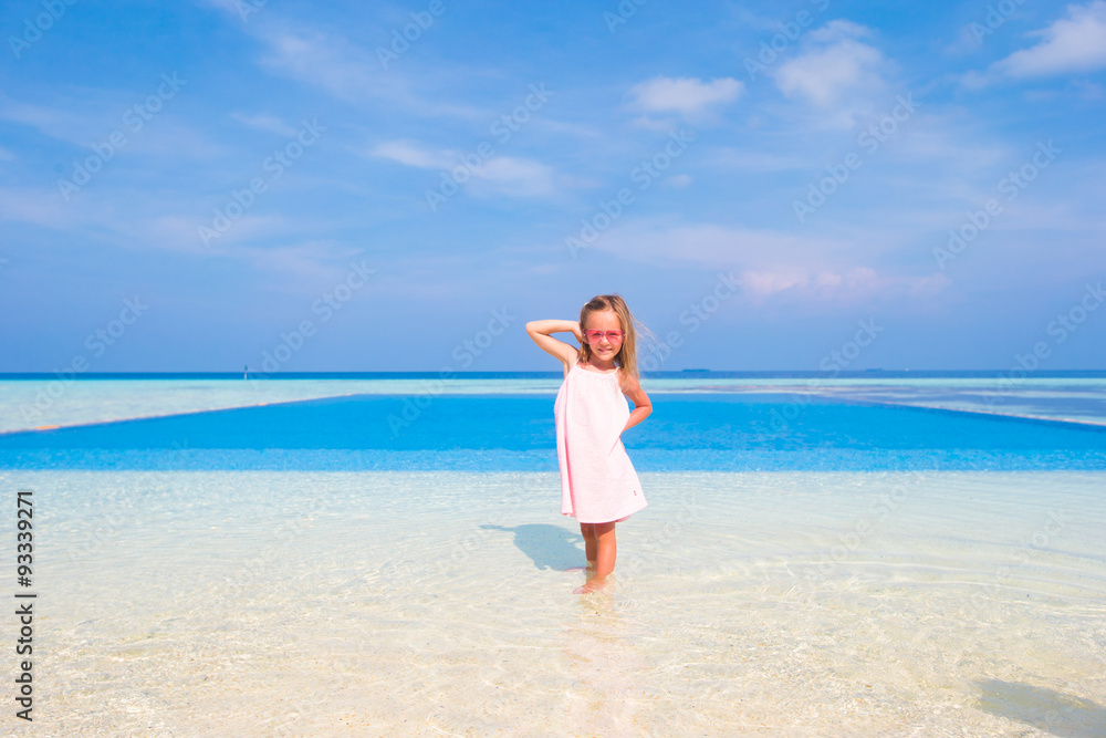 Adorable little girl at beach during summer vacation Adorable little girl at beach during summer vacation