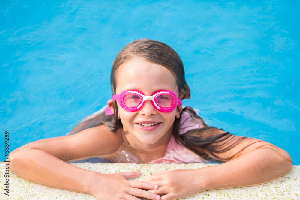 Adorable little girl in outdoor swimming pool