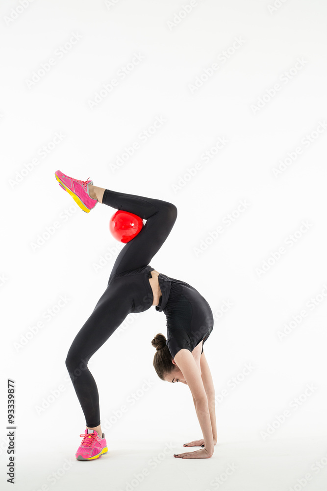 Rhythmic gymnast with ball in studio Rhythmic gymnast with ball in studio
