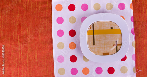 colored plates on a red tablecloth