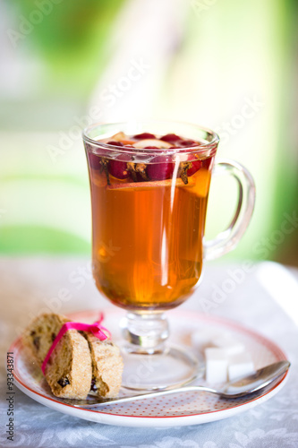 glass Cup of fruit tea with biscuits