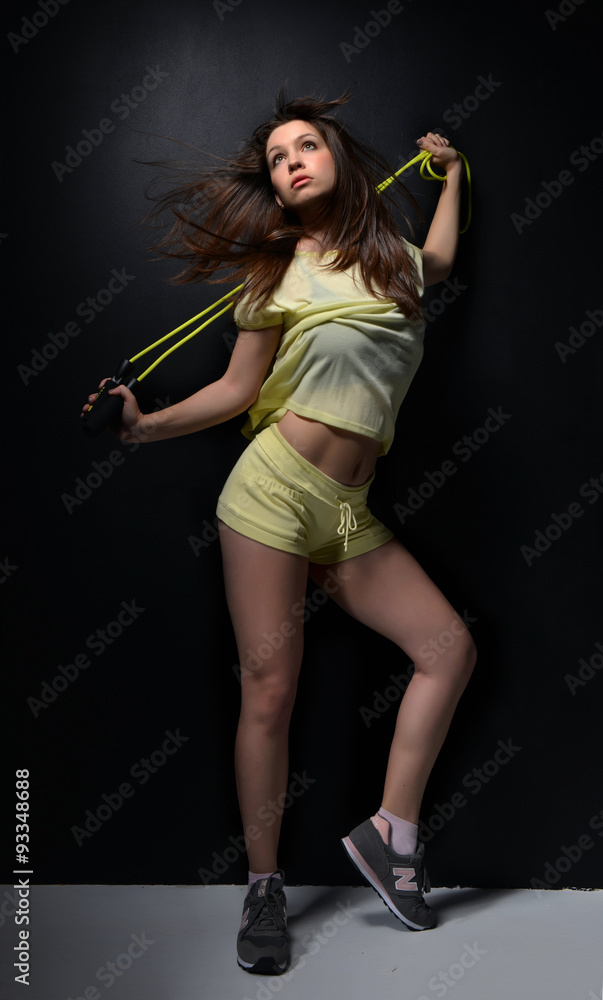 Young beautiful fitness sport woman with the jump rope posing Young beautiful fitness sport woman with the jump rope posing