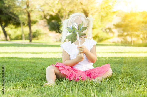 Little Girl In Grass Blowin...