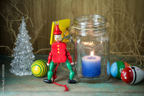 Wooden toy soldier in red uniform decoration and candle
