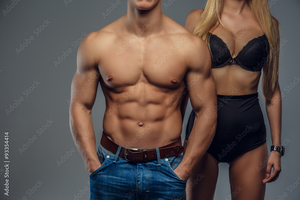 Shirtless muscular man and woman in black underwear. Shirtless muscular man and woman in black underwear.
