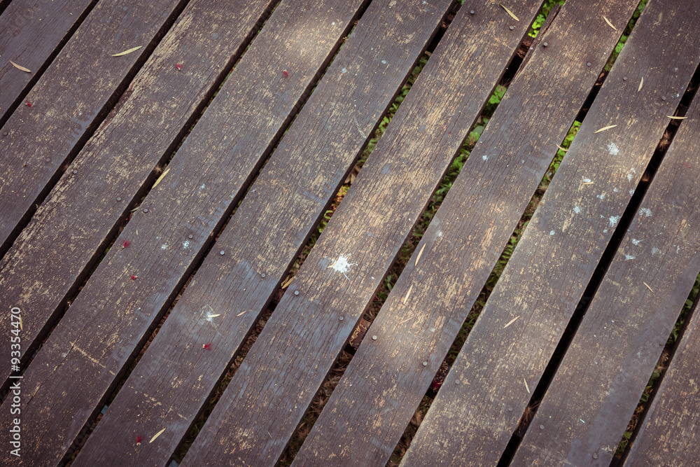 old wooden walkway with falling leaves in the morning of autumn old wooden walkway with falling leaves in the morning of autumn