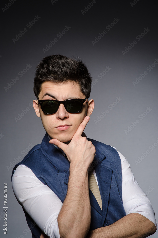 Young man in blue vest against gray Young man in blue vest against gray
