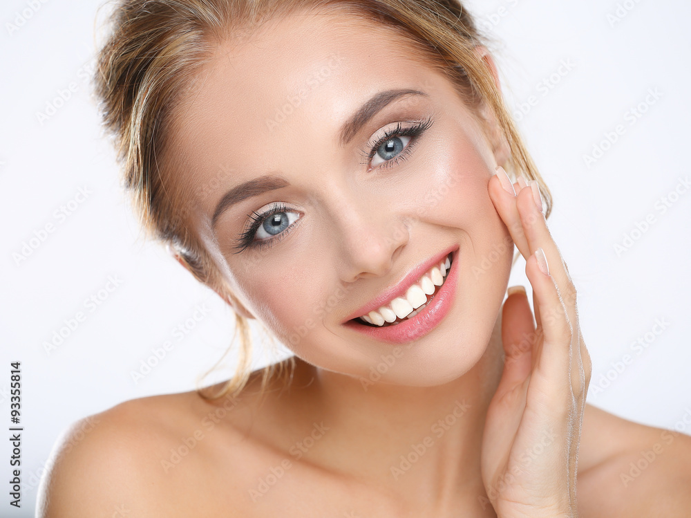 Young woman touching her face isolated on white background Young woman touching her face isolated on white background