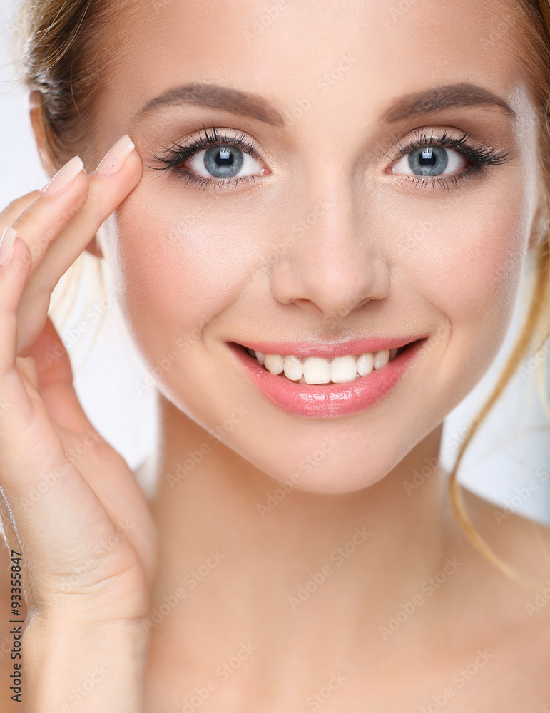 Fototapeta premium Young woman touching her face isolated on white background