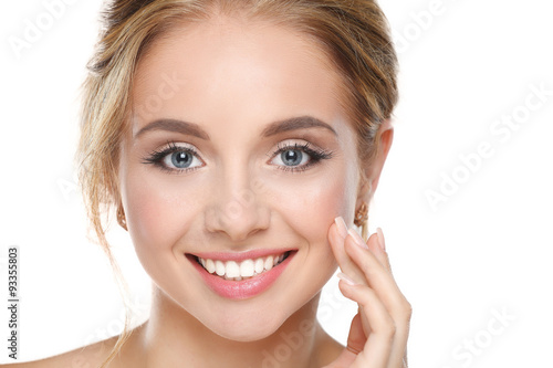 Young woman touching her face isolated on white background
