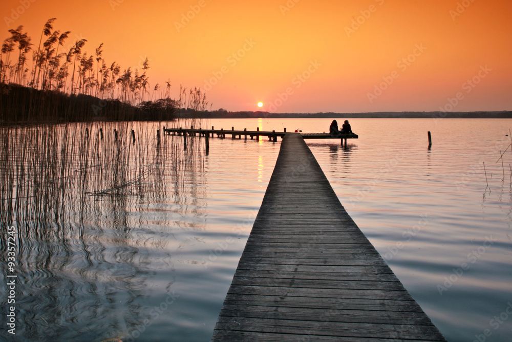 Fototapeta premium Lake in denmark with a jetty in winter shot with colour graduate