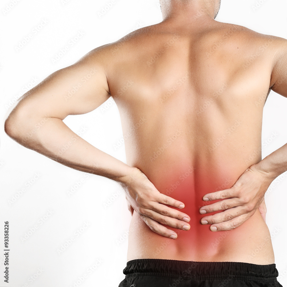 Studio shot of young man with pain in back Studio shot of young man with pain in back