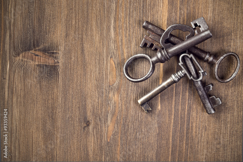 Old keys at right top of wooden background