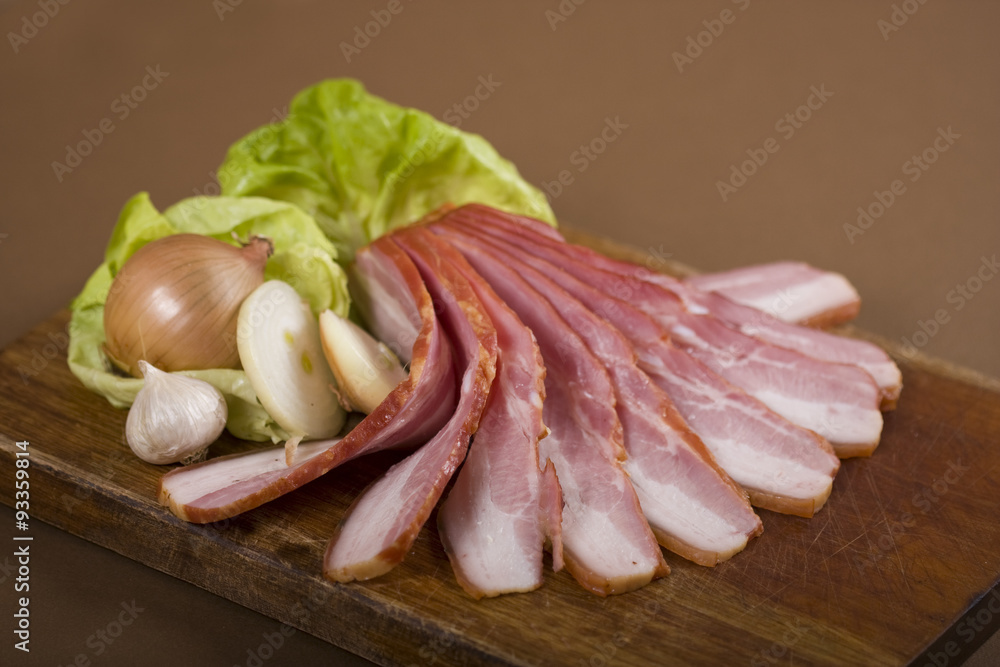 Sliced bacon on wooden tray Sliced bacon on wooden tray