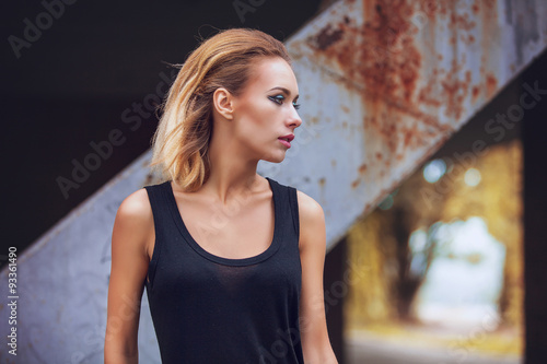 modern punk fashion, portrait of a beautiful model posing over street background