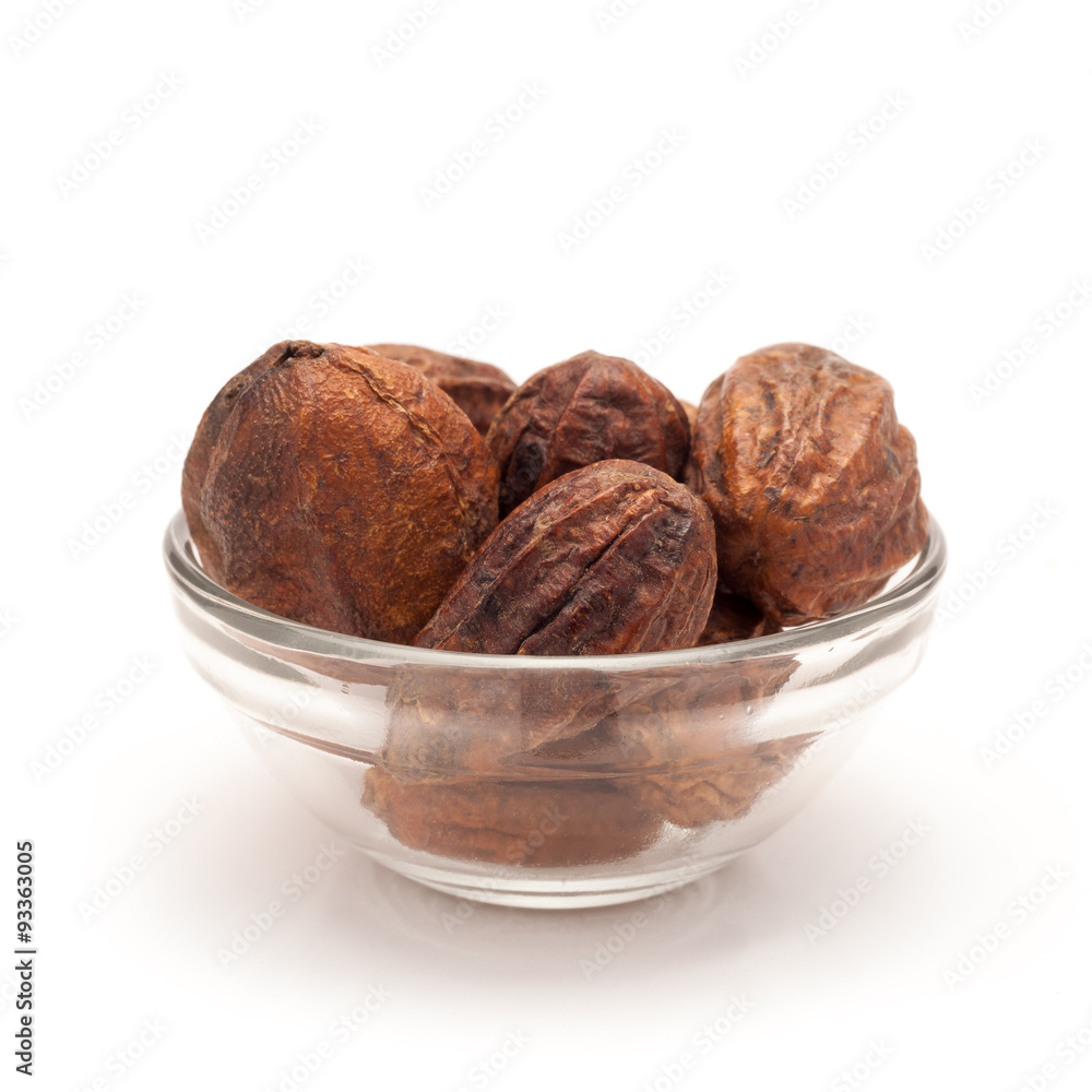 Front view of Organic Inknut or Harr (Terminalia chebula) in glass bowl isolated on white background. Front view of Organic Inknut or Harr (Terminalia chebula) in glass bowl isolated on white background.