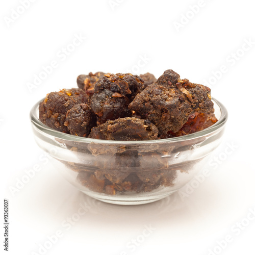Front view of Organic Indian bdellium or Guggul resin (Commiphora wightii) in glass bowl isolated on white background. photo