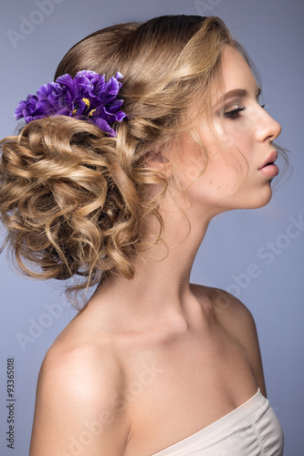 beautiful blond girl in image of the bride with purple flowers