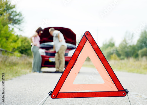 Adult man and women near broken car