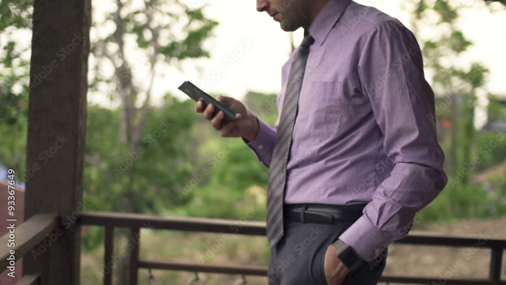 Young businessman using smartphone on terrace, slow motion 240fps
Young businessman using smartphone on terrace, slow motion 240fps